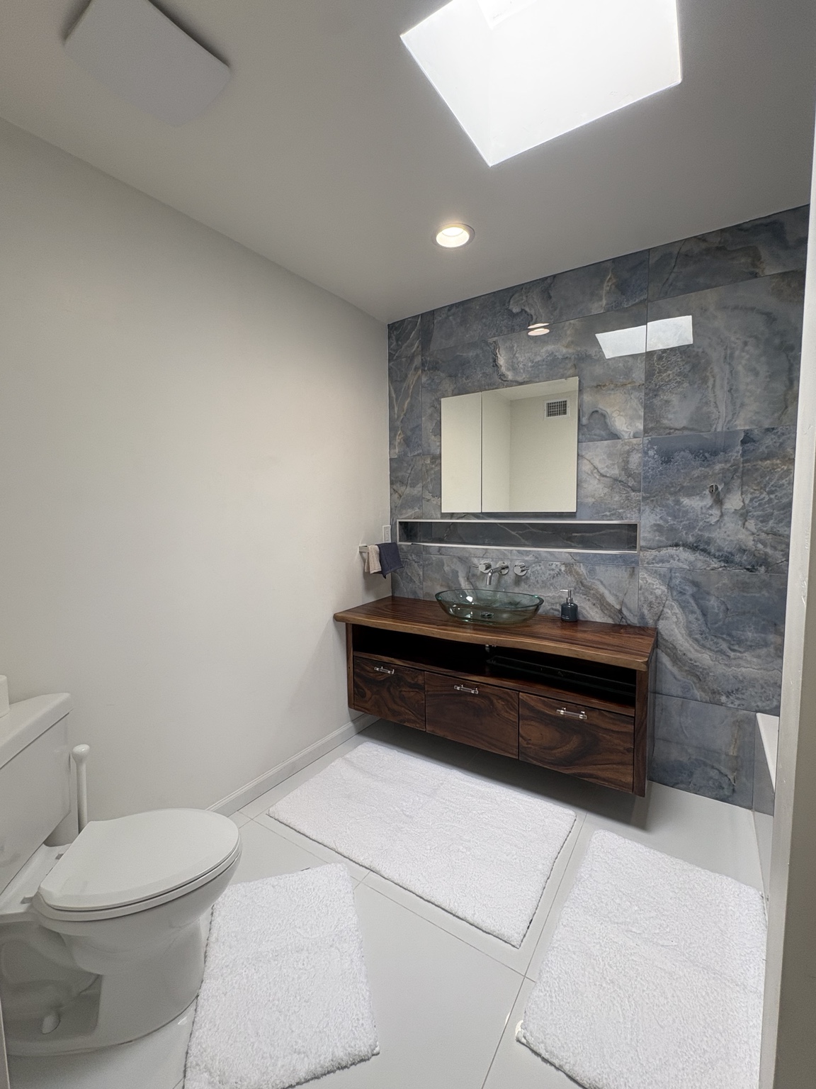 Floating vanity and stone feature wall